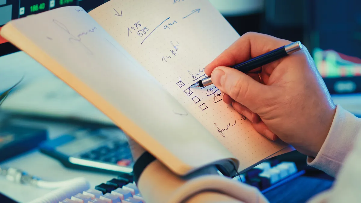 AI writing SaaS review methodology — The Complete Guide — Person Writing in Notebook for Stock Market Planning