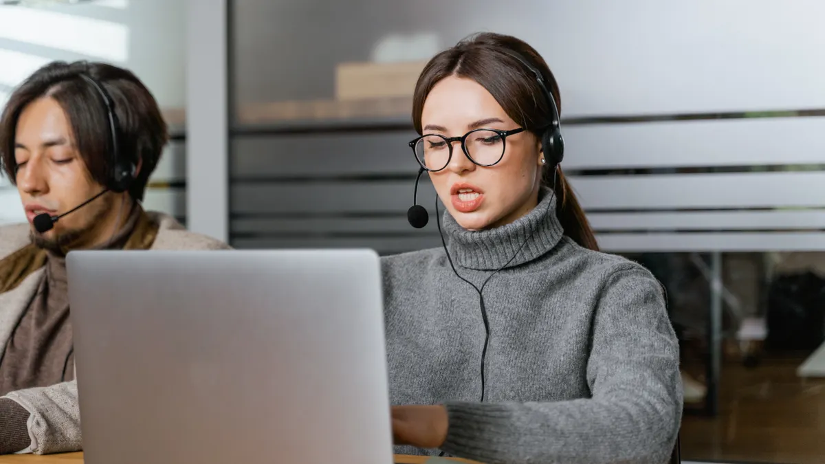 AI writing SaaS support options — The Complete Guide support agent working on a laptop with headset