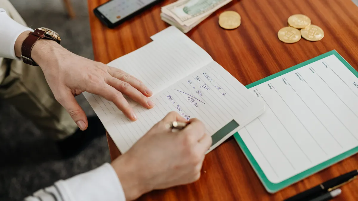 Best AI Writing SaaS for Budget Buyers — A Person Writing on Notebook Using a Pen