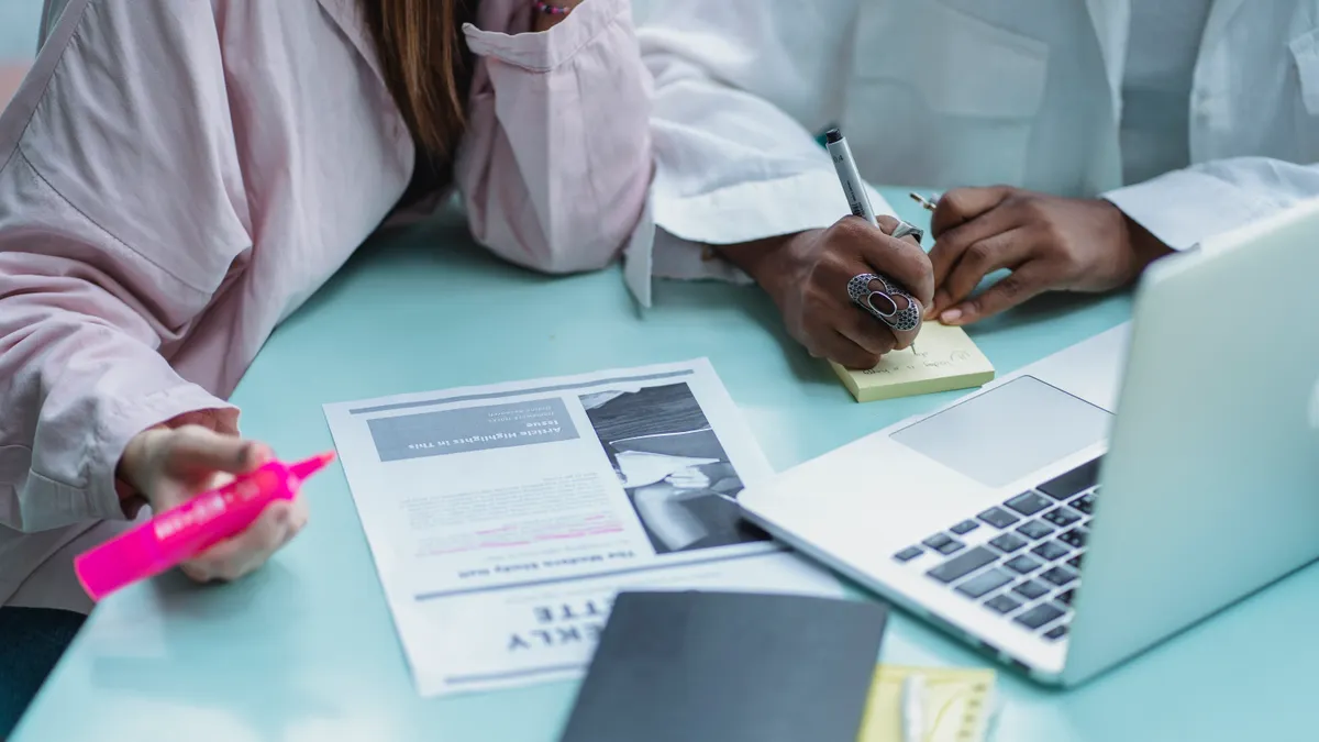 Best AI Writing SaaS for Long-Form Articles Best AI Writing SaaS for Long-Form Articles — Crop multiracial students writing on sticky notepad near laptop