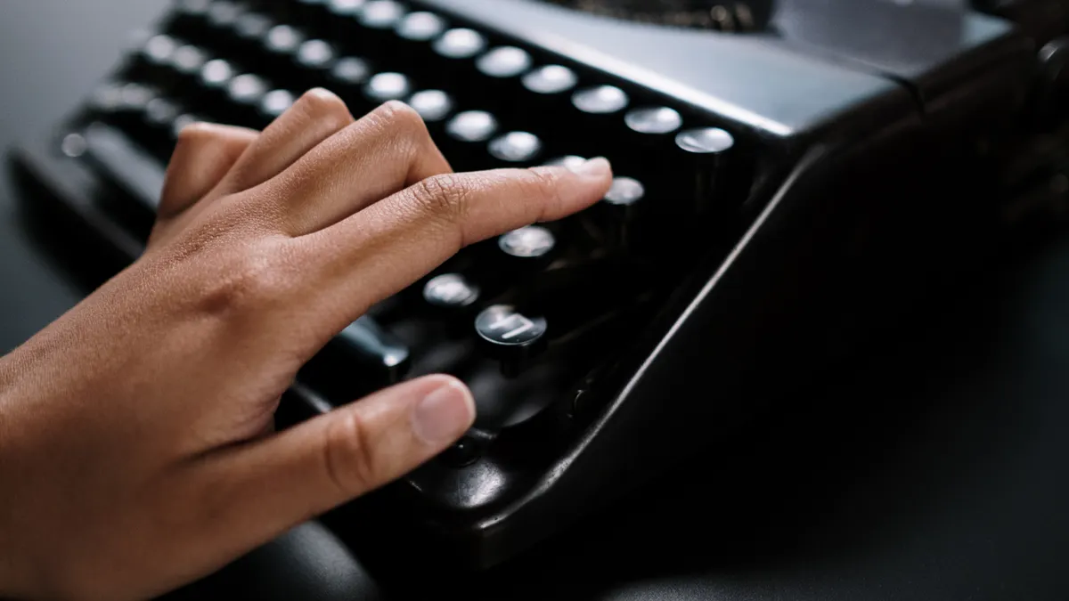 How We Test AI Writing Tool Usability — Woman Writing on an Old Typing Machine