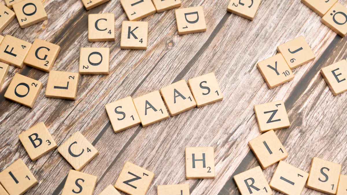 Rytr Review Rytr Review — Scrabble letters spelling saas on a wooden table